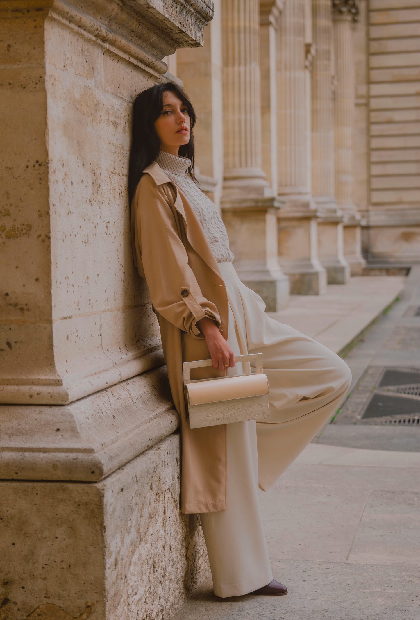 ARCHIVE 02 by atelier &LAB — rectangular Mineral Composite (stone-based material) bag with integrated Mineral handle and Premium beige leather insert, carried in a Minimalist Brutalist Architectural setting at the Louvre, Paris.