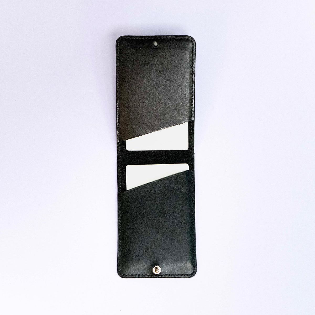 MagSafe compatible leather smartphone card holder — MODULE Pliable by atelier &LAB, black upcycled full-grain calf leather shown open, Paris design studio.