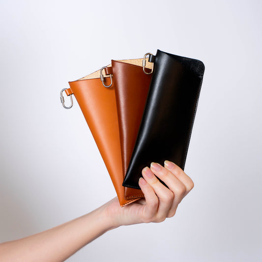 MODULE eyewear case by atelier &LAB — handheld trio in black, brown and cognac revealing a refined, minimalist composition in premium upcycled full-grain calf leather.