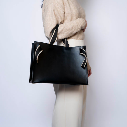 NUMÉRO 02 by atelier &LAB — carried front view expressing a refined, minimalist presence and quiet luxury ease in premium upcycled full-grain calf leather, Paris.