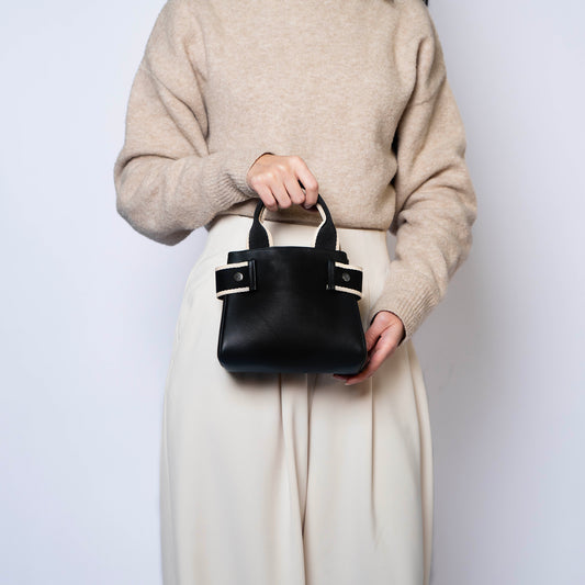 NUMÉRO 04 mini by atelier &LAB — hand-held front view expressing an effortless, quiet luxury attitude within a compact, architectural micro-volume in premium upcycled full-grain calf leather, Paris.