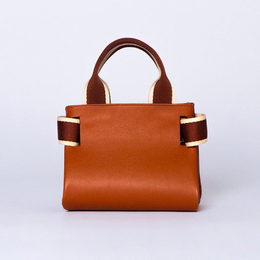 Mini leather handbag in cognac — NUMÉRO 04 by atelier &LAB, rear view, compact graphic shape