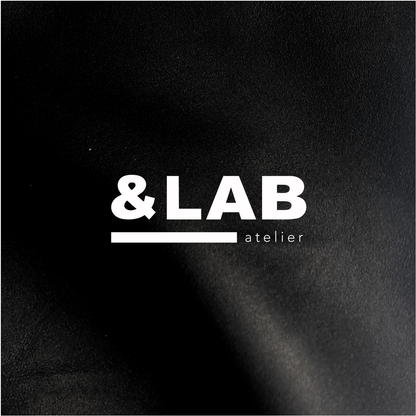 Atelier &LAB official logo embossed-style on premium black full-grain leather — Minimalist luxury craftsmanship, Paris.