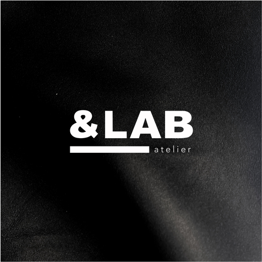 Atelier &LAB official logo embossed-style on premium black full-grain leather — Minimalist luxury craftsmanship, Paris.