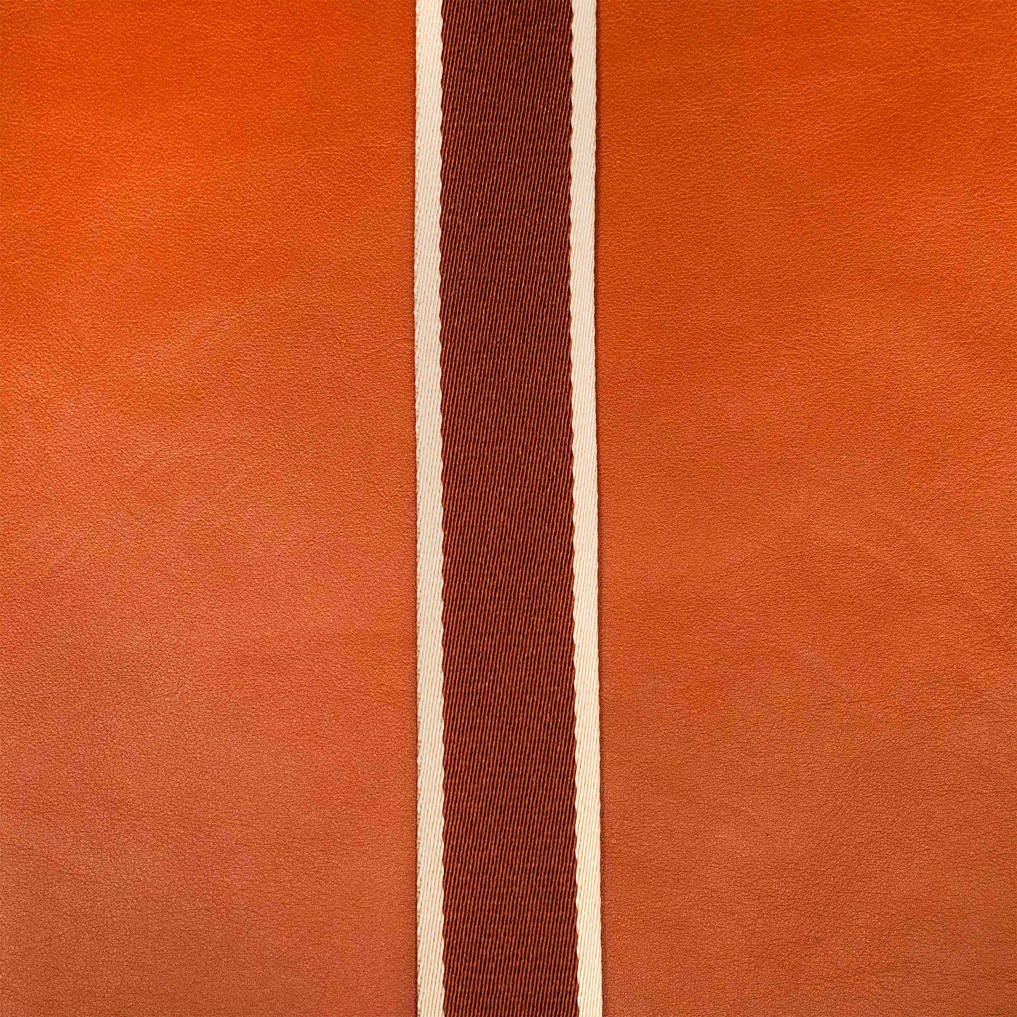 Detail view of atelier &LAB materials — premium cognac upcycled full-grain calf leather with a technical woven polyester strap, clean minimalist composition.