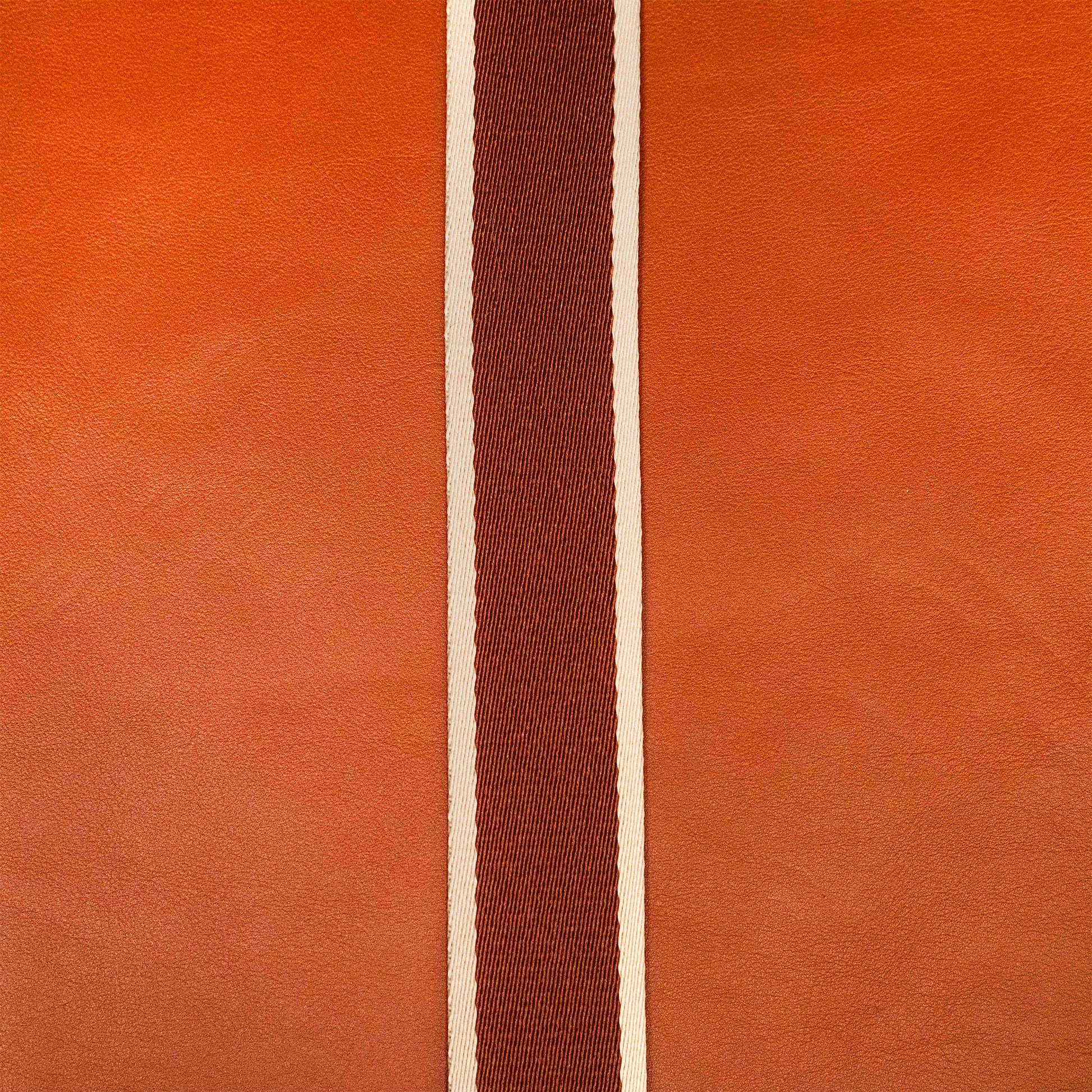 Detail view of atelier &LAB materials — premium cognac upcycled full-grain calf leather with a technical woven polyester strap, clean minimalist composition.