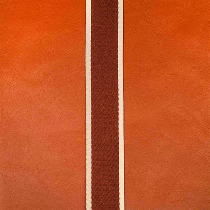 Detail view of atelier &LAB materials — premium cognac upcycled full-grain calf leather with a technical woven polyester strap, clean minimalist composition.