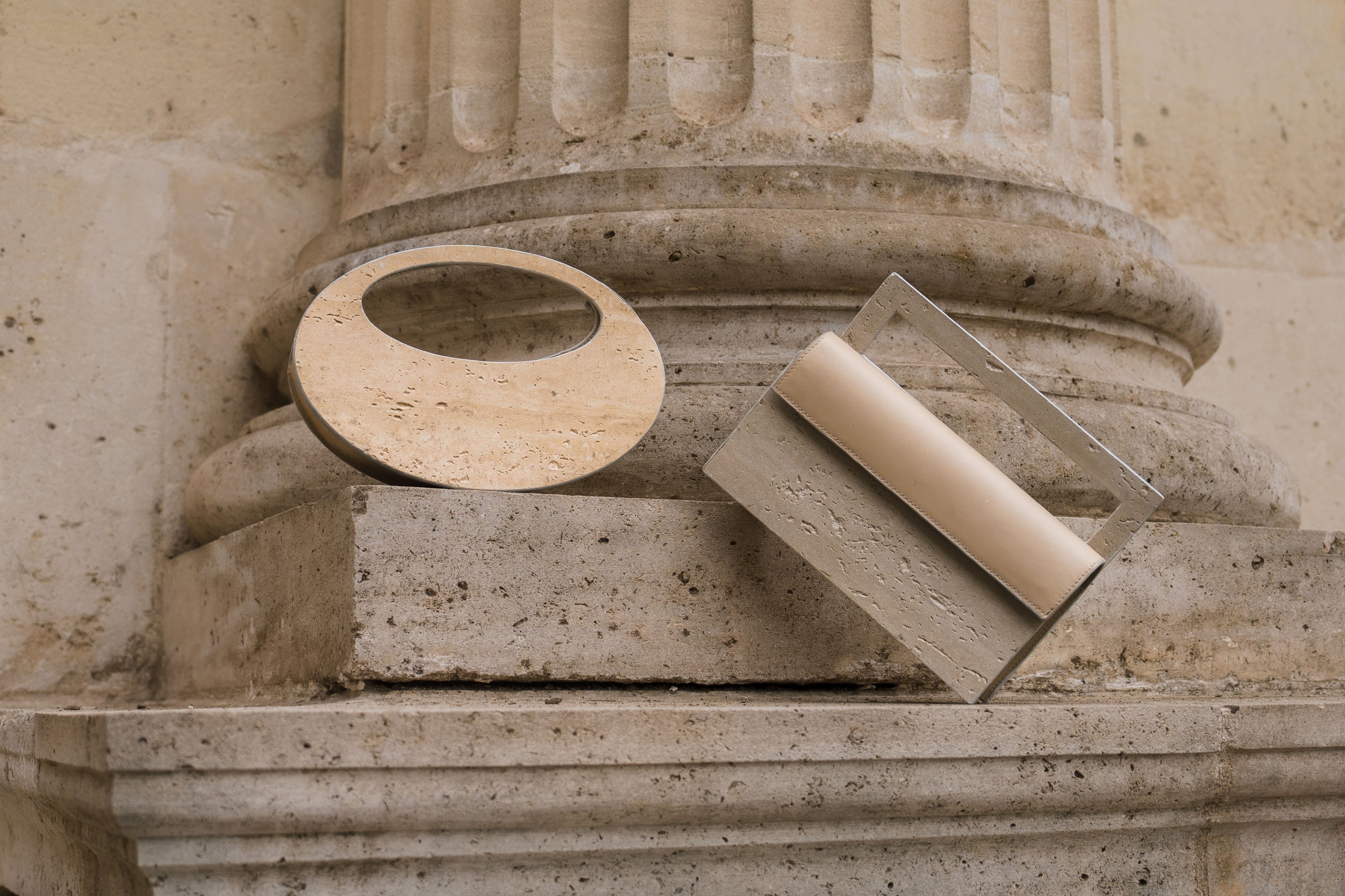 Mineral composite sculptural objects — MINERAL 01 and MINERAL 02 by atelier &LAB, frontal view highlighting circular and rectangular structured forms and balanced proportions in mineral composite material, Paris design studio.