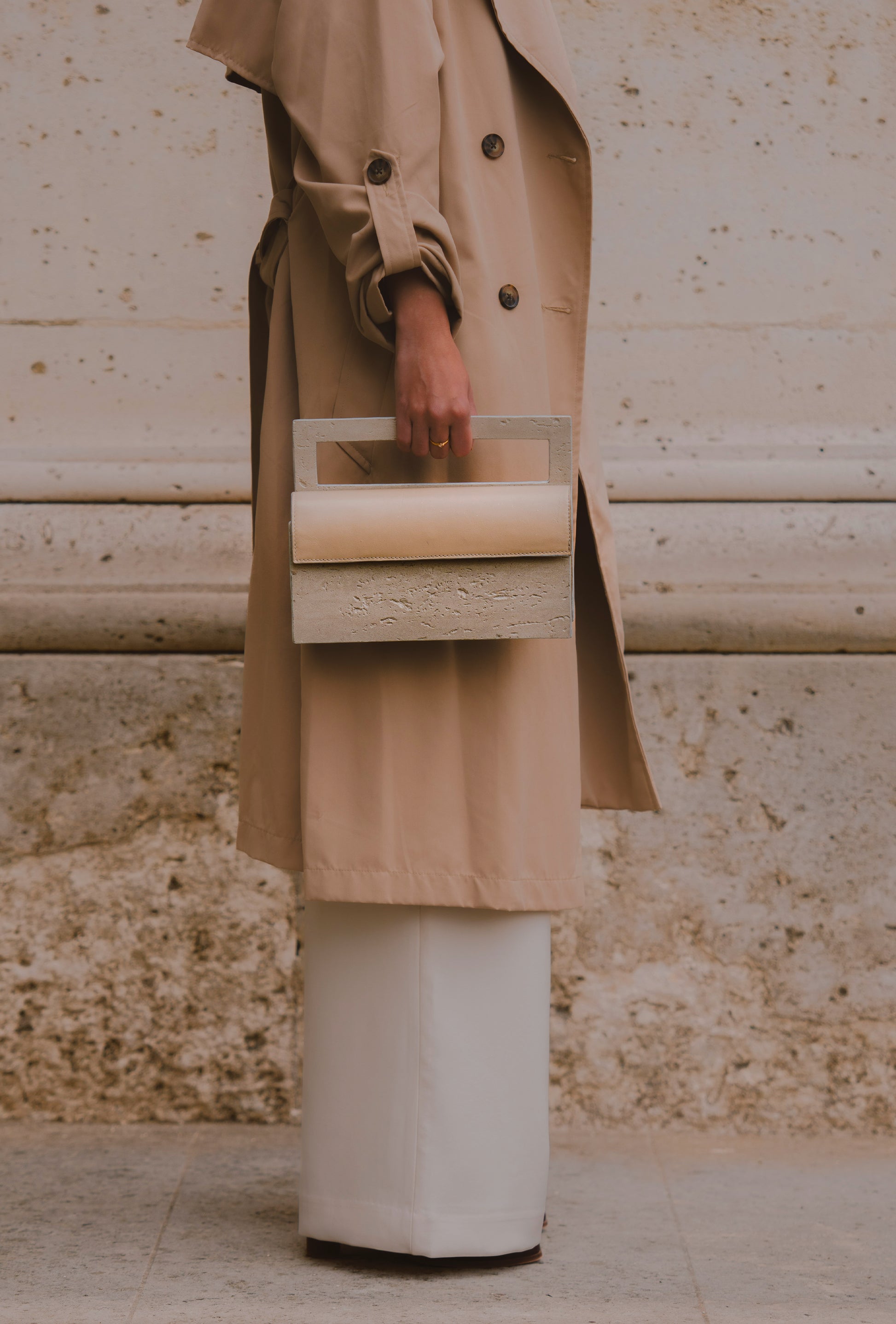 Mineral composite sculptural object — MINERAL 02 by atelier &LAB, hand-held frontal view highlighting the rectangular structured form and balanced proportions in mineral composite material, Paris design studio.