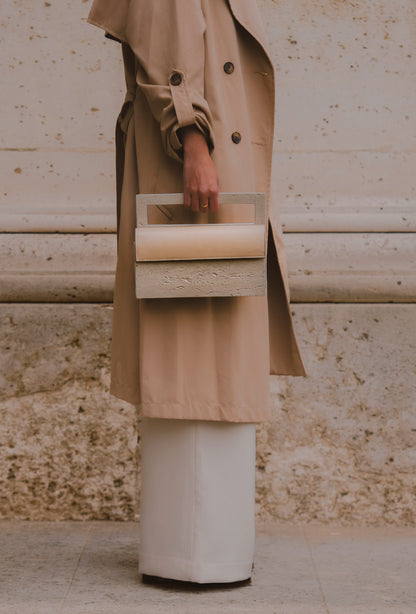 Mineral composite sculptural object — MINERAL 02 by atelier &LAB, hand-held frontal view highlighting the rectangular structured form and balanced proportions in mineral composite material, Paris design studio.