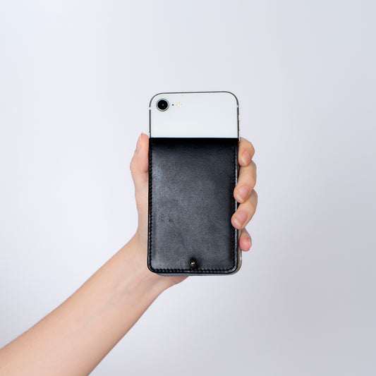 MODULE card holder double by atelier &LAB — front view attached to iPhone, expressing a clean, architectural silhouette in black, premium upcycled full-grain calf leather, Paris.