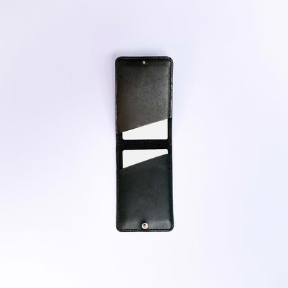 MODULE card holder by atelier &LAB — open interior view in hand, highlighting a refined, minimalist folding structure in black, premium upcycled full-grain calf leather, Paris.