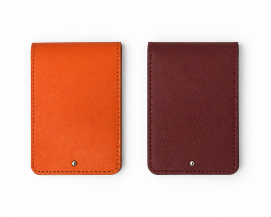 Front view of two closed MODULE Pliable card holders by atelier &LAB in orange and Bordeaux upcycled full-grain calf leather, featuring visible stitching and metal snap closures. Designed and made near Paris.