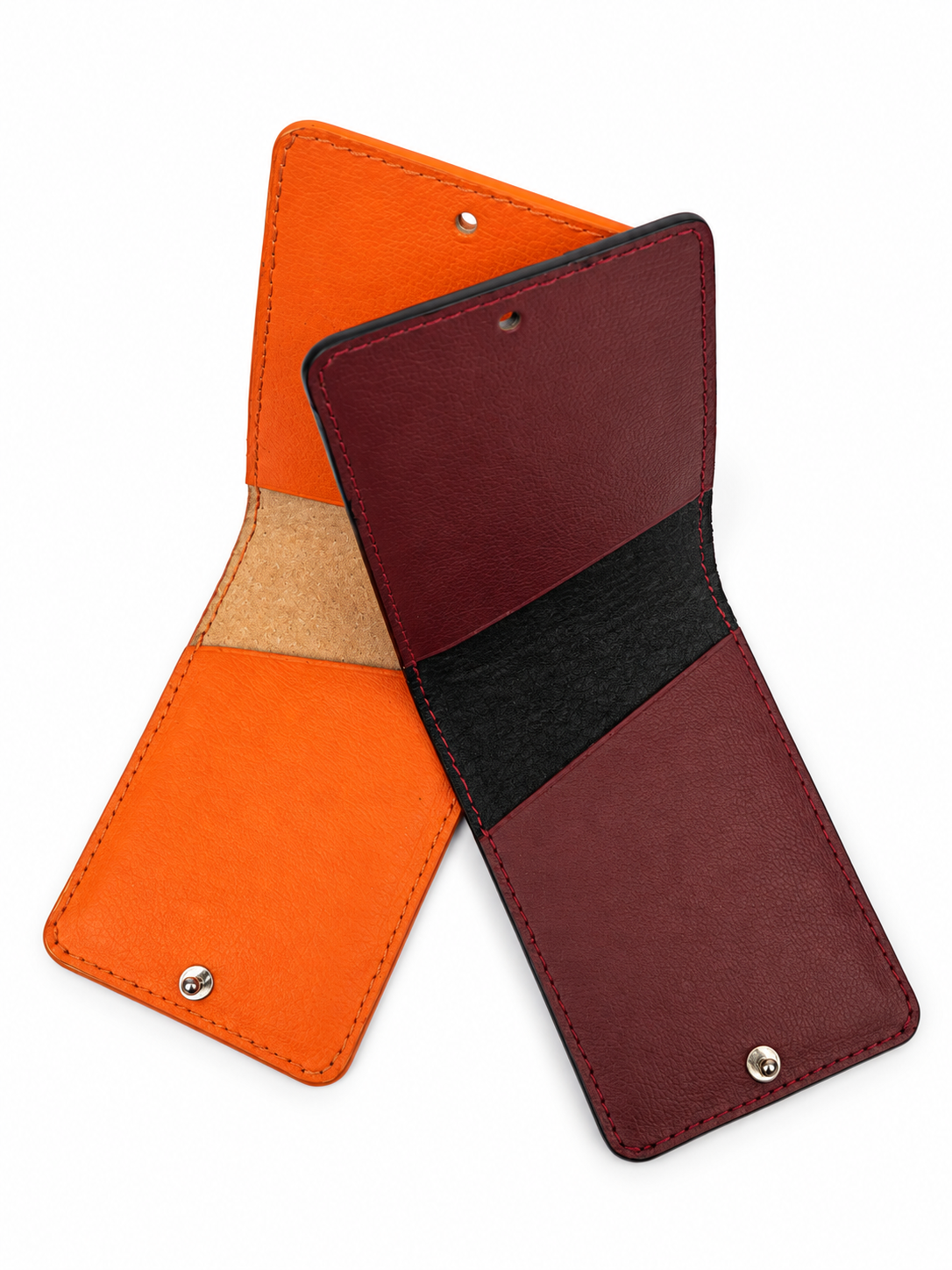 Open view of two MODULE Pliable leather card holders by atelier &LAB in orange and Bordeaux upcycled full-grain calf leather, showing the interior card compartments, suede lining and metal snap closures. Designed and made near Paris.
