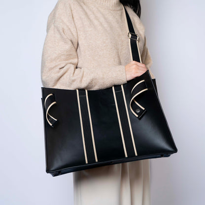 NUMÉRO 01 by atelier &LAB — worn on shoulder with strap, rear view emphasizing an architectural carry and generous volume in premium upcycled full-grain calf leather, Paris.