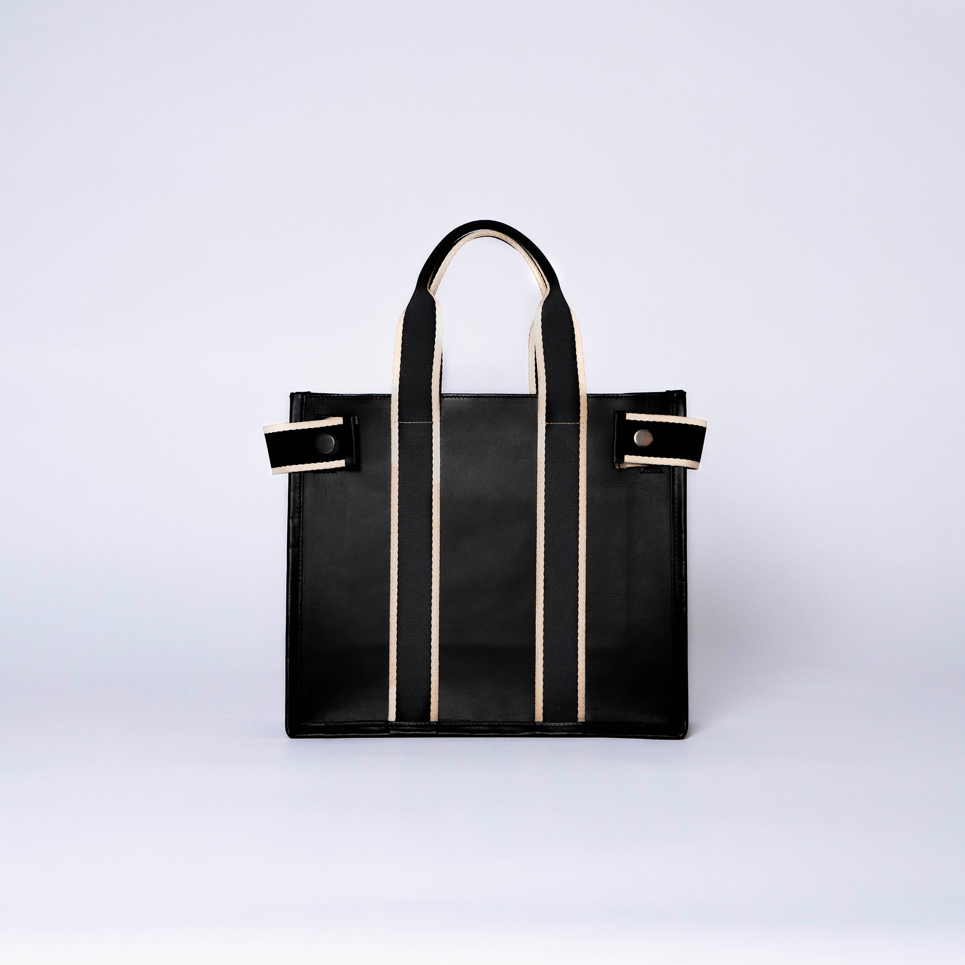 NUMÉRO 01 by atelier &LAB — frontal view capturing a clean, graphic silhouette with architectural clarity in premium upcycled full-grain calf leather, Paris.