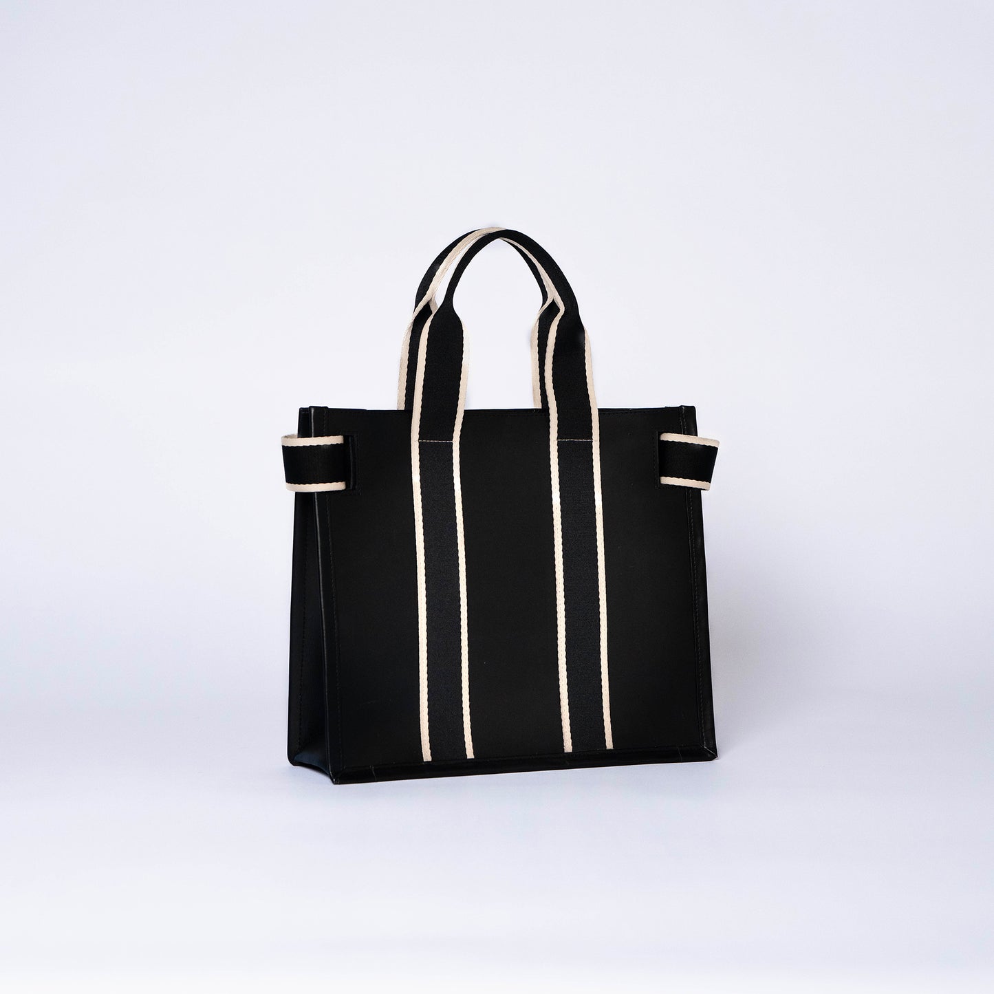 Structured leather tote bag — NUMÉRO 01 S by atelier &LAB, rear three-quarter view showing structured silhouette in black upcycled full-grain calf leather