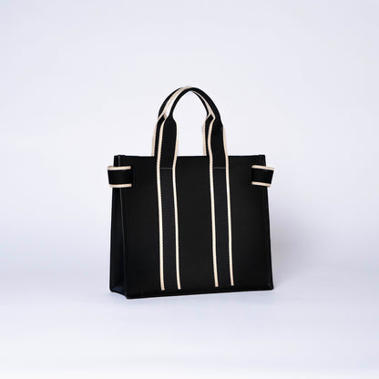 Structured leather tote bag — NUMÉRO 01 S by atelier &LAB, rear three-quarter view showing structured silhouette in black upcycled full-grain calf leather