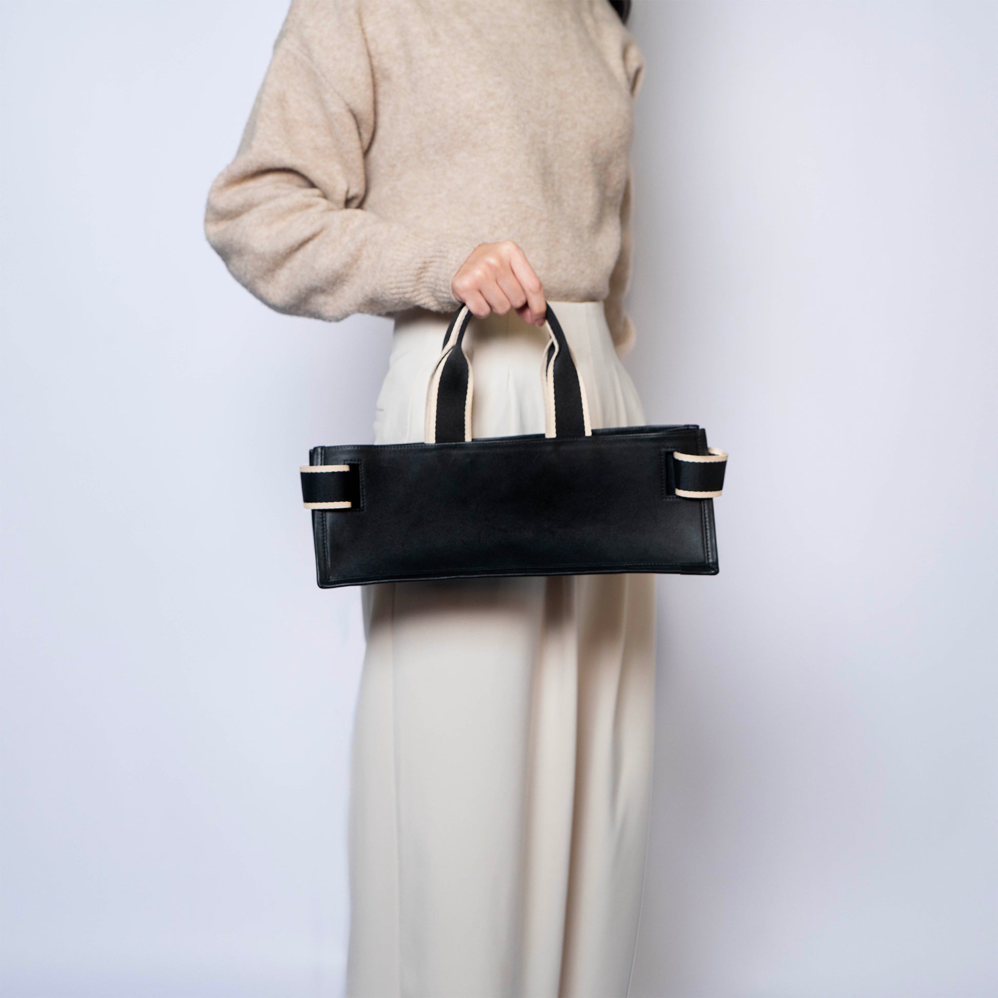 NUMÉRO 02 by atelier &LAB — clean rear angle revealing a precise, flat architectural volume in premium upcycled full-grain calf leather, Paris.