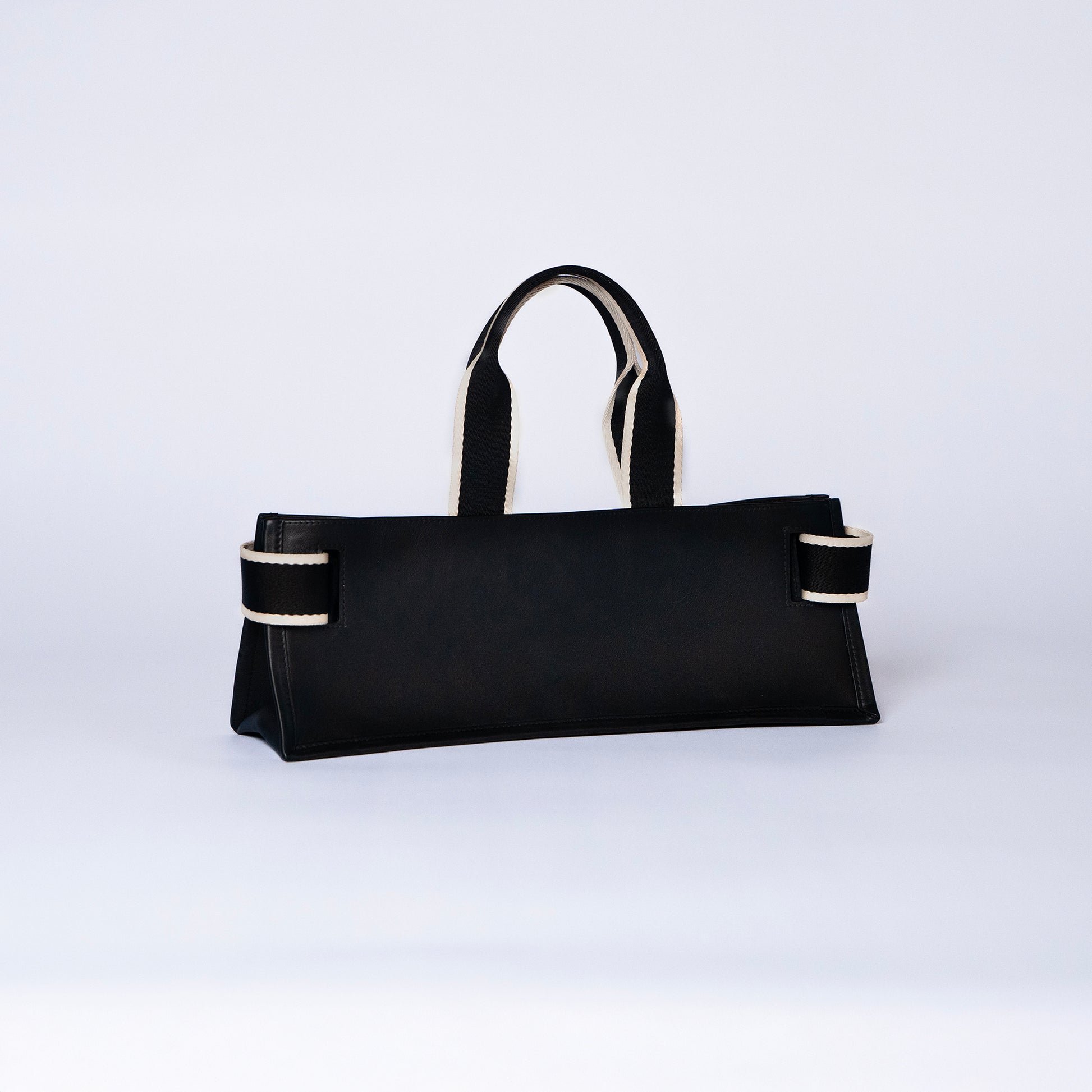 NUMÉRO 02 by atelier &LAB  — Large flat tote bag in black. Structured horizontal silhouette, rear three-quarter view.  Premium upcycled full-grain calf leather, brutalist aesthetic, Parisian life style