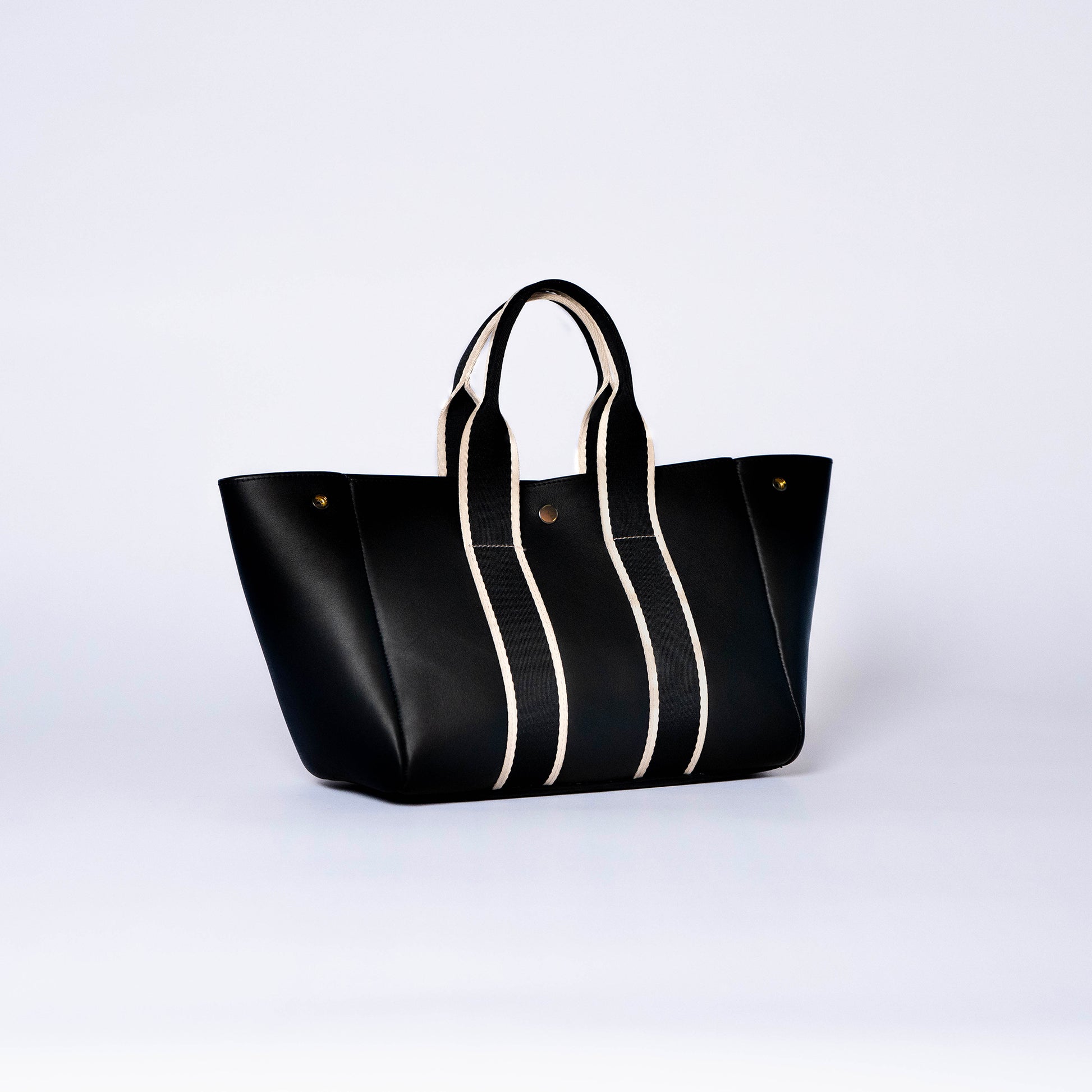 Everyday leather tote bag — NUMÉRO 03 by atelier &LAB, black upcycled full-grain calf leather, front three-quarter view showing an open shape and easy access for daily essentials.