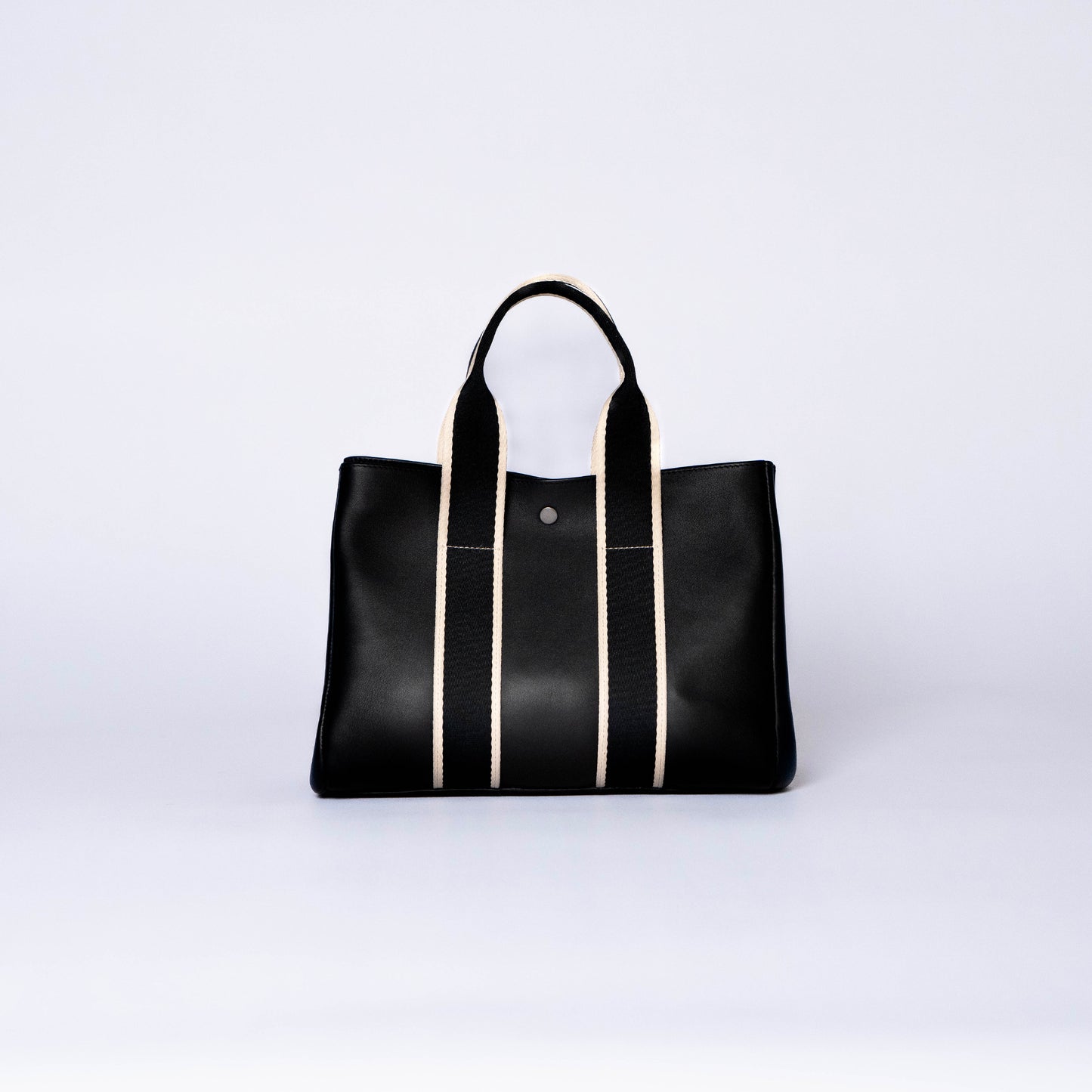 NUMÉRO 03 by atelier &LAB — rear view revealing a deep black, architectural volume with restrained, sculptural lines in premium upcycled full-grain calf leather, Paris.