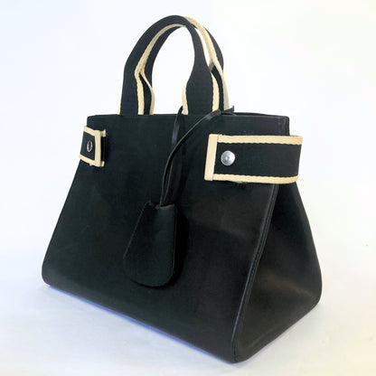 Structured leather handbag — NUMÉRO 04 M prototype by atelier &LAB, rear three-quarter view showing volume and structure