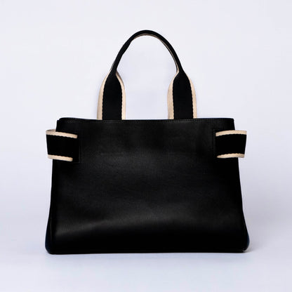 Structured leather handbag — NUMÉRO 04 by atelier &LAB, black upcycled full-grain calf leather, rear view showing a clean functional silhouette designed for everyday use.