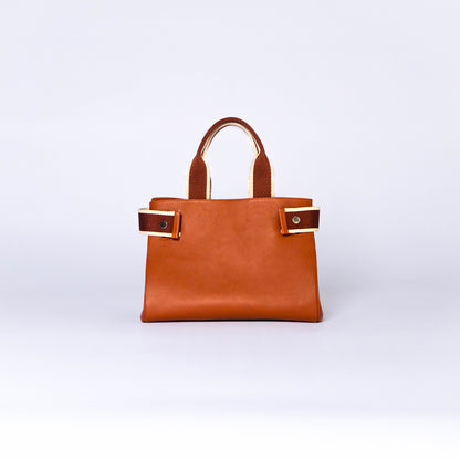 NUMÉRO 04 by atelier &LAB — frontal view capturing a refined, minimalist façade with sculpted volume in premium upcycled full-grain calf leather, Paris.