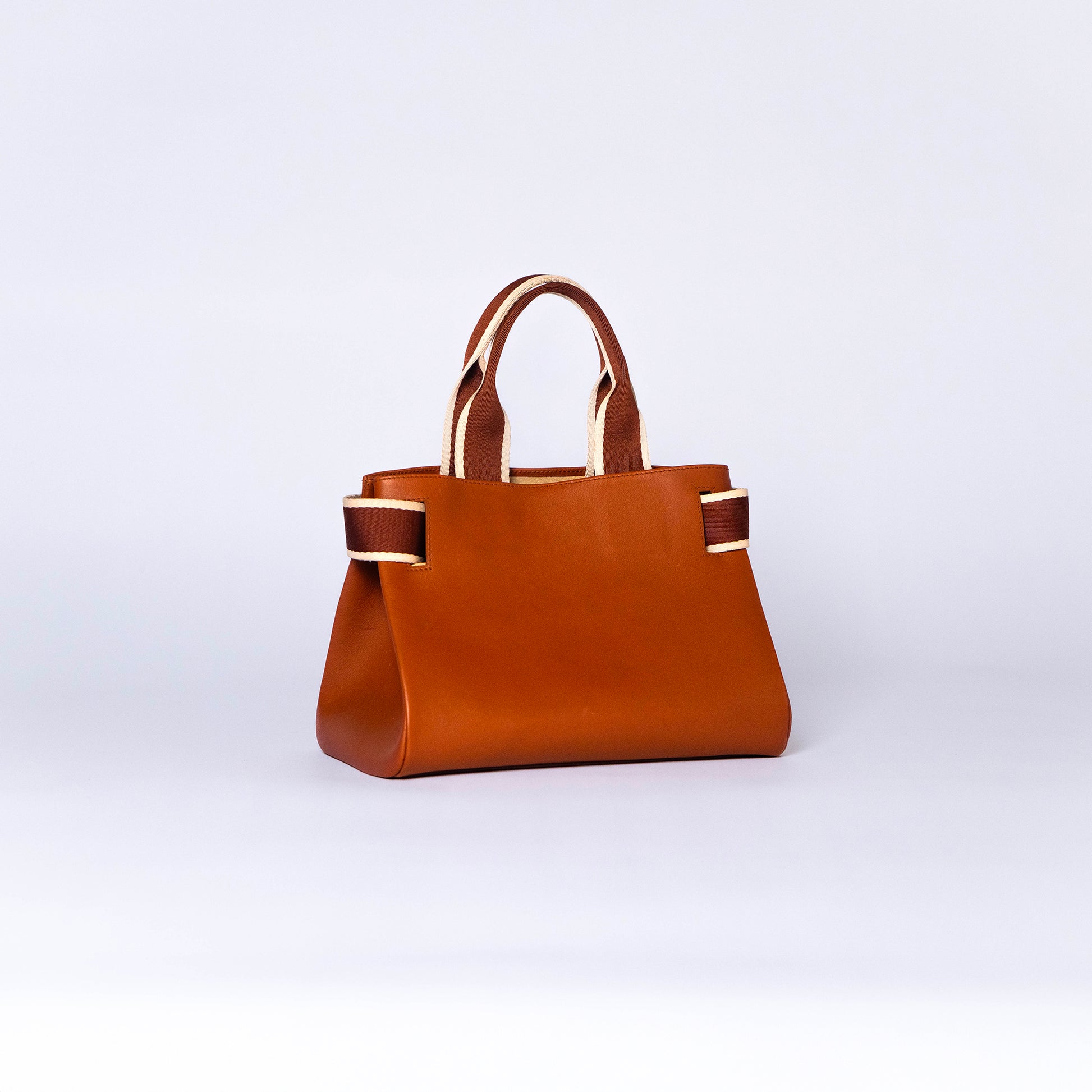 NUMÉRO 04 by atelier &LAB — rear three-quarter view highlighting a warm cognac tone and architectural structure in premium upcycled full-grain calf leather, Paris.