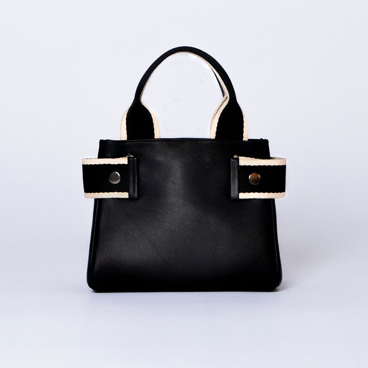 Mini leather handbag in black — NUMÉRO 04 by atelier &LAB, front view, compact graphic shape