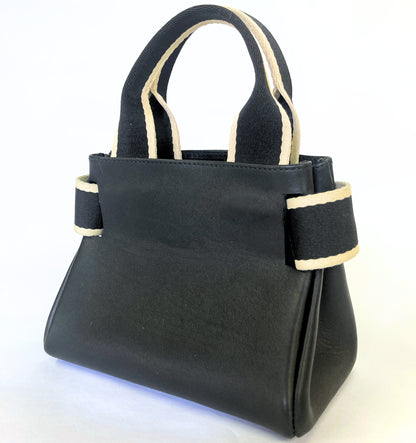 Structured leather handbag — NUMÉRO 04 Mini prototype by atelier &LAB, three-quarter view showing structured volume and side construction
