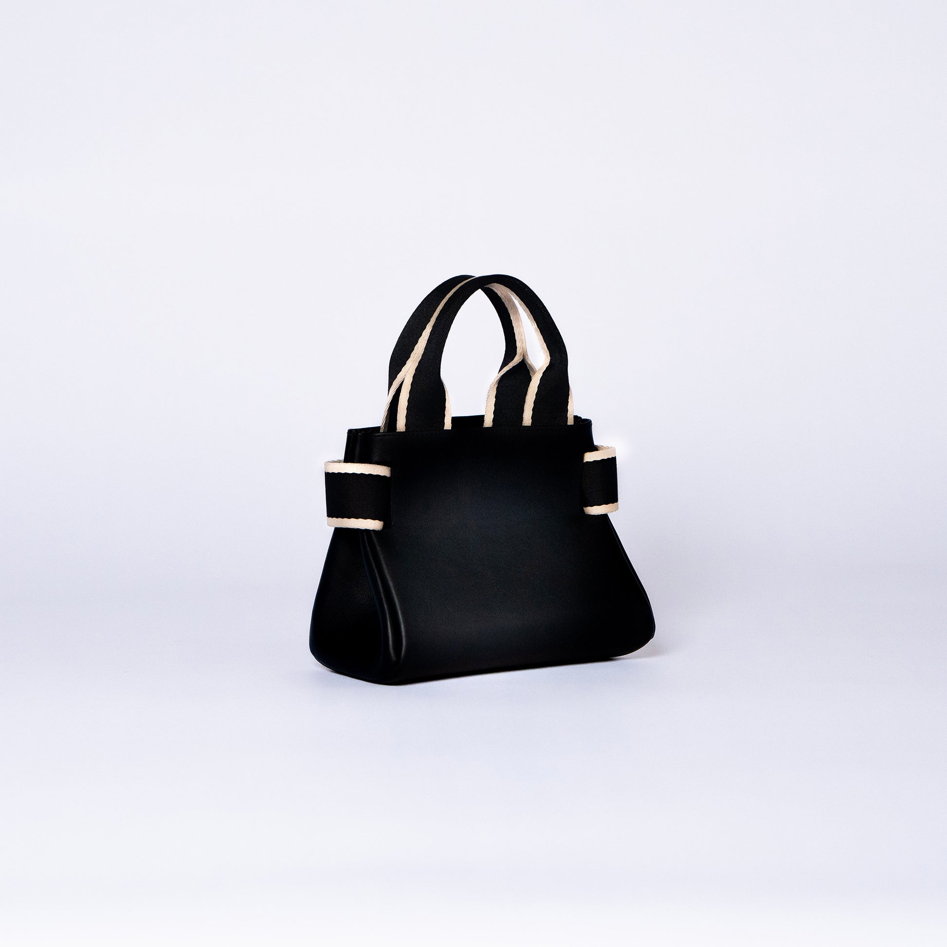 NUMÉRO 04 mini by atelier &LAB — rear three-quarter view highlighting a precise, compact silhouette with sculptural restraint in premium upcycled full-grain calf leather, Paris.