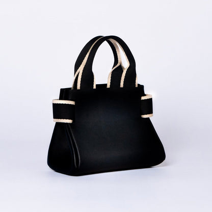 Mini leather handbag in black — NUMÉRO 04 by atelier &LAB, rear three-quarter view, compact graphic shape
