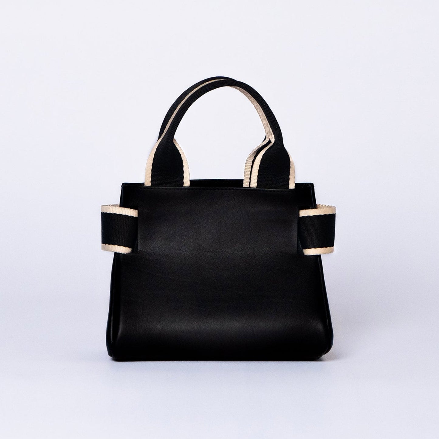 Mini leather handbag in black — NUMÉRO 04 by atelier &LAB, rear view, compact graphic shape