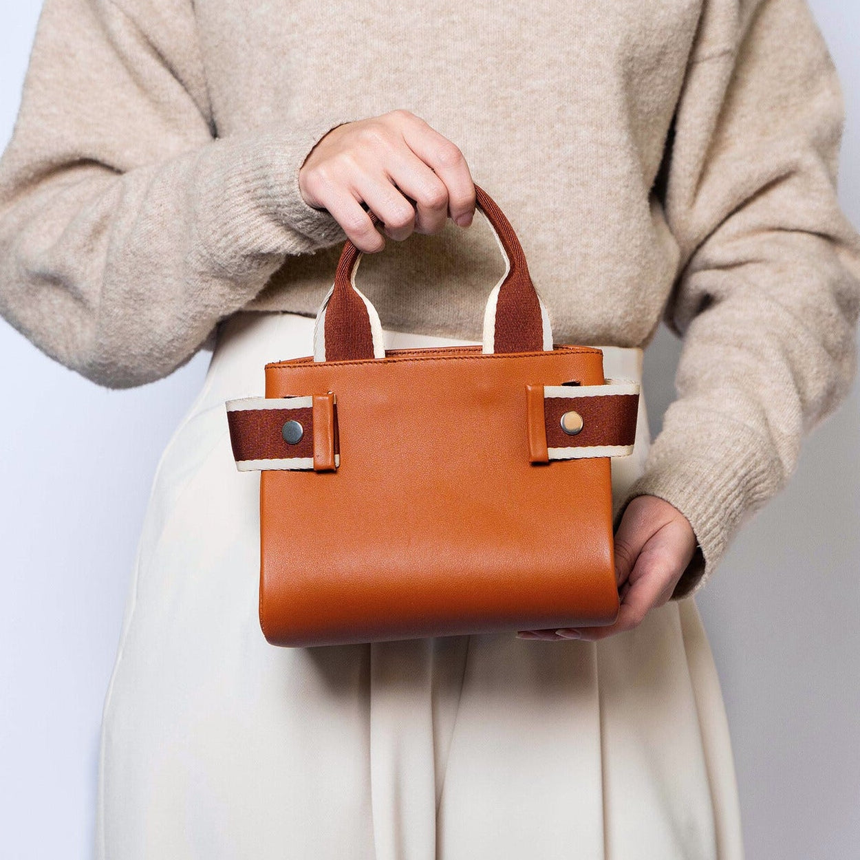 Mini leather handbag in cognac — NUMÉRO 04 by atelier &LAB, handheld, front view