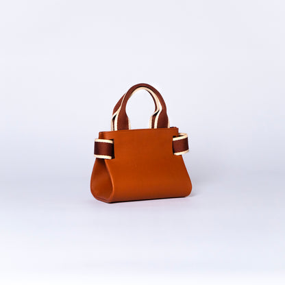 NUMÉRO 04 mini by atelier &LAB — rear three-quarter view revealing a compact, sculptural micro-volume with architectural tension in premium upcycled full-grain calf leather, Paris.