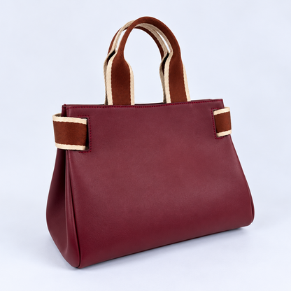 Three-quarter view of the NO04 M handbag in Bordeaux upcycled calf leather by Hiroki AMANO — atelier &LAB, showing its softly structured silhouette, folded sides and contrasting rust and ecru woven handles. Designed and made near Paris.